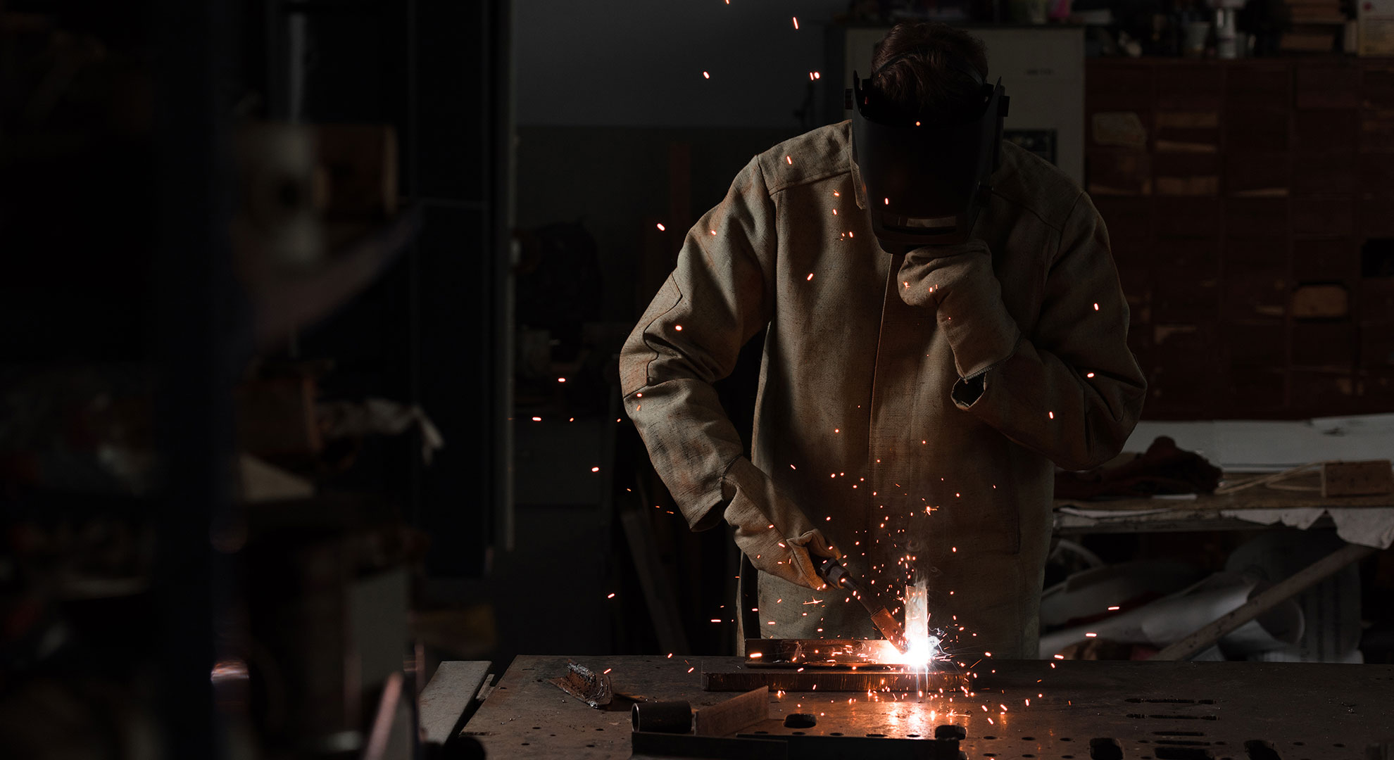 worker-in-protection-mask-welding-metal-at-factory-HCVQRJG.jpg